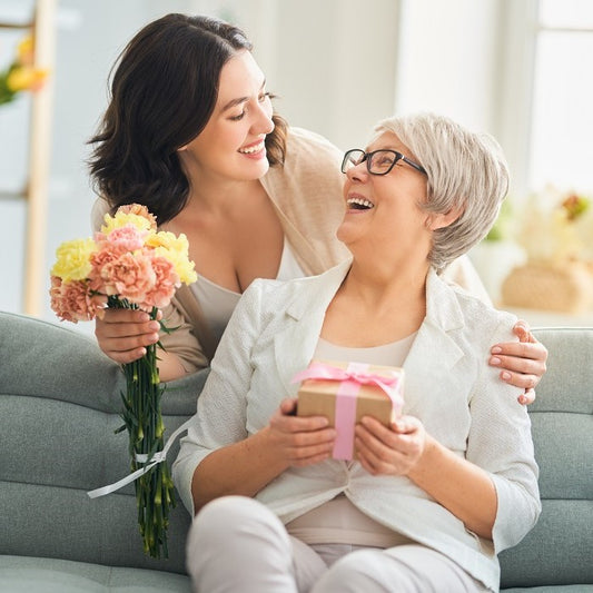 Daughter gives mother gifts and flowers